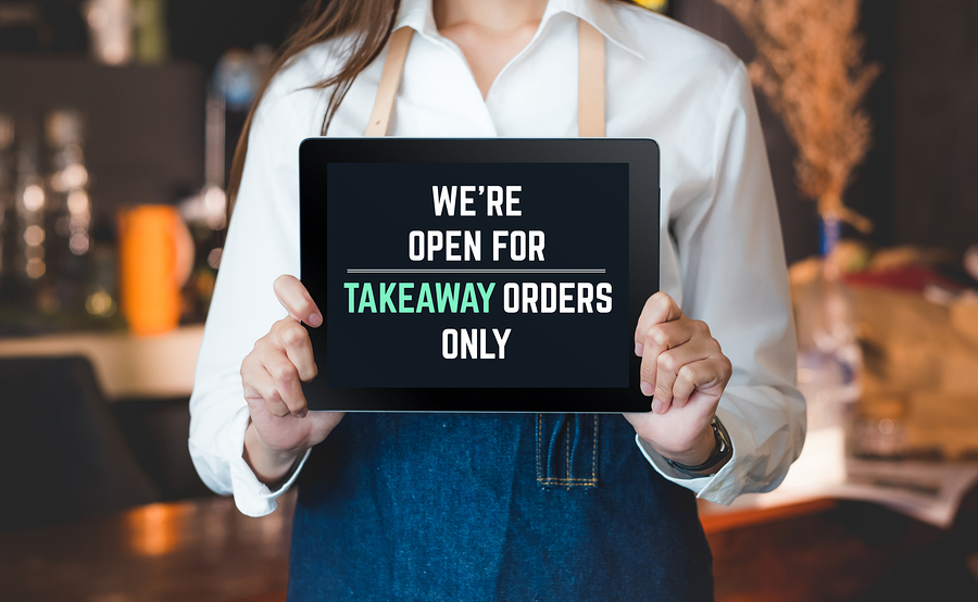 tabblet sign were open for takeaway orders only infront of counterbar social distancing