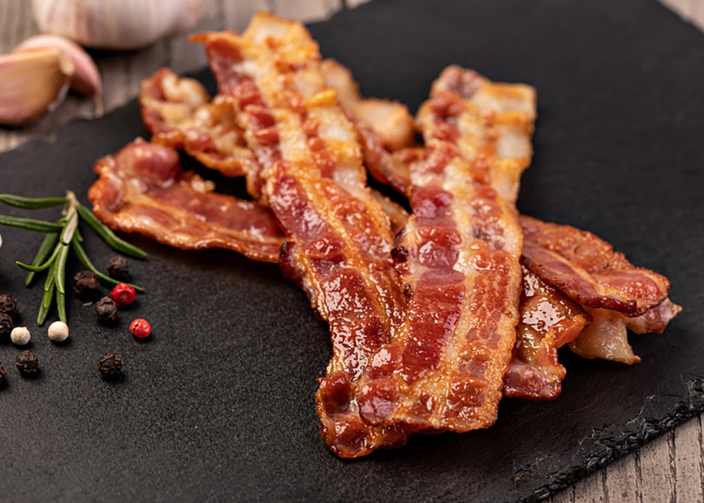 Closeup of slices of crispy hot fried bacon