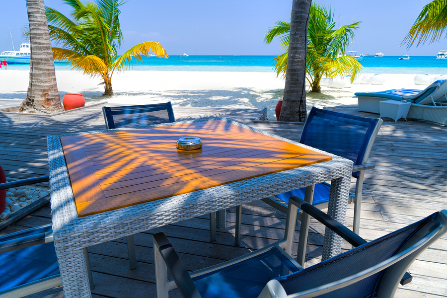 Outdoors beach restaurant. Tropical resort coast, relaxing summer shore. Luxury resort restaurant, chairs and tables in elegant set up