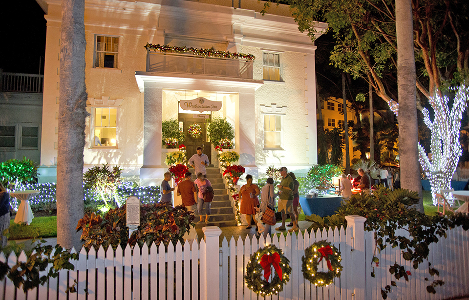 Revelers enjoy Key West’s warm tropical ambience Friday evening on the grounds of the Weatherstation Inn at 57 Front Street, one of five beautifully decorated locations visited during night one of the annual Holiday Historic Inn Tours.A second evening of tours, which will include visits to Hemingway Rum Company Distillery, Old Town Manor, Wicker Guesthouse, The Mermaid & The Alligator, Suite Dreams Inn, and Santa Maria Suites Resort, is set for Friday, December 14. Presented by First State Bank, Historic Tours of America, Margaritaville Key West Resort & Marina, Ocean Key Resort, The Lodging Association of the Florida Keys & Key West, and the Monroe County Tourist Development Council. For more information visit KeyWestHolidayFest.com. (Photo Carol Tedesco/KeyWestHolidayFest.com)